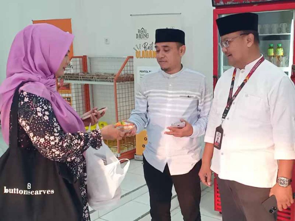 Fajar (kanan) memperkenalkan daging olahan RPH Surabaya kepada Rita (kiri), pelanggan daging RPH Surabaya, Jumat, (22/03/2024).